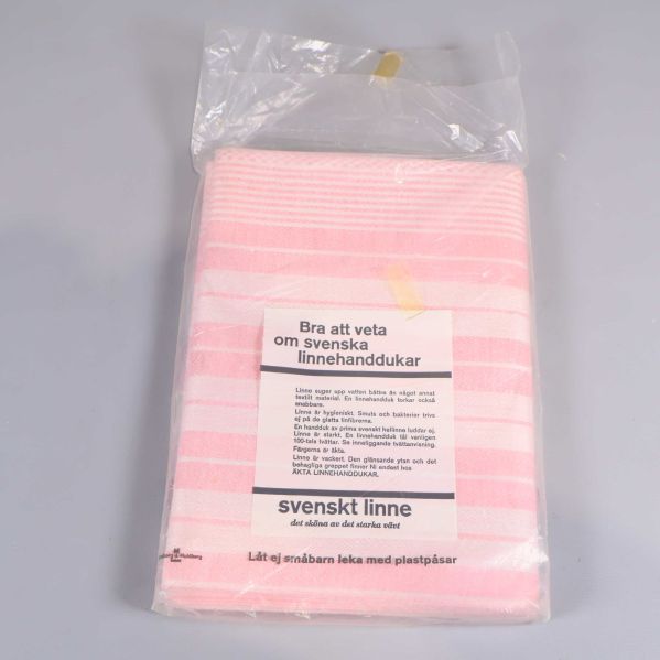 Baksida av linnehandduk, visar öppen förpackning