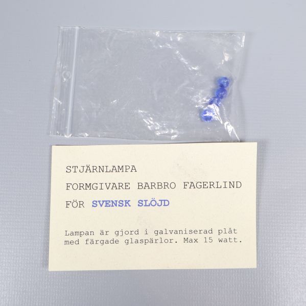 Informationslapp om stjärnlampa och designer Barbro Fagerlind