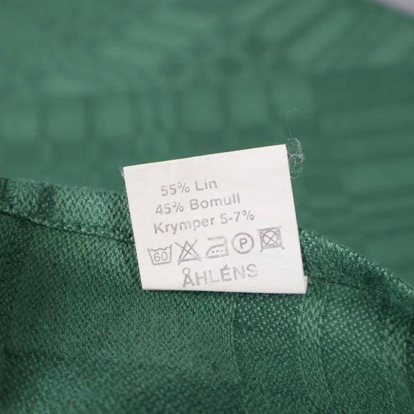 Materialetikett visar lin och bomull Åhléns