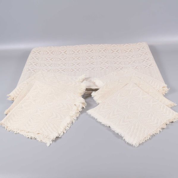 Duk och sex servetter i ljus textil med geometriskt mönster