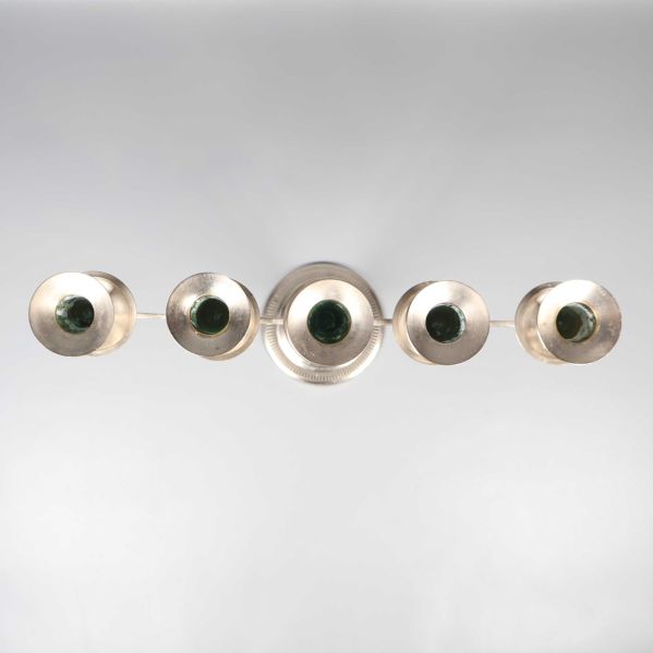 Vy uppifrån på fem ljushållare arrangerade i rad