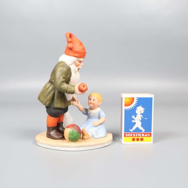 Tomte med barn och tändsticksask för storleksjämförelse