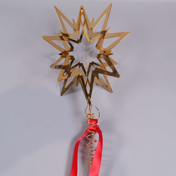 Närbild på Topstjärna av metall med spiral