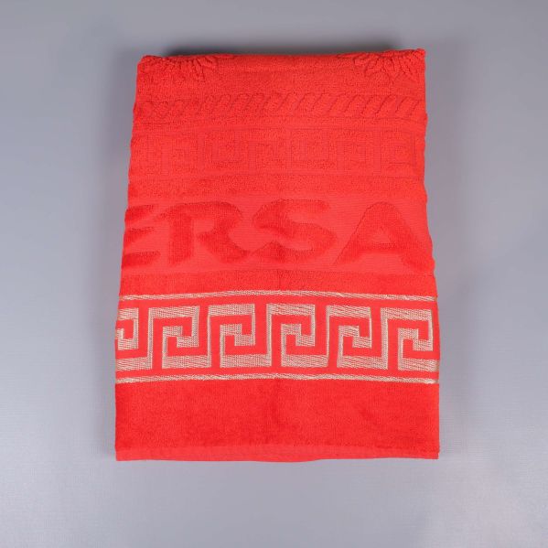 Röd, vikt handduk med dekorativa bårder