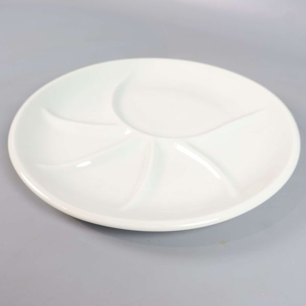 Närbild på en vit tallrik med fyra fack