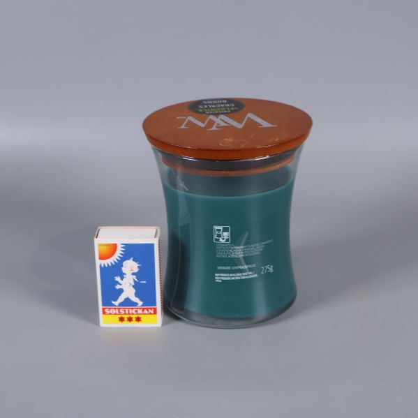 Doftljus bredvid tändsticksask för storleksreferens