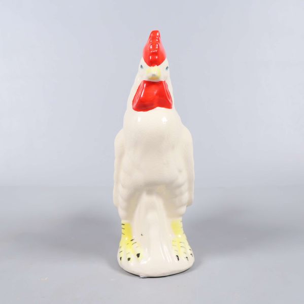 Keramisk tuppfigur sedd rakt framifrån