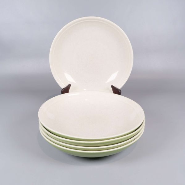 Fem djupa tallrikar med ljus insida och grön utsida