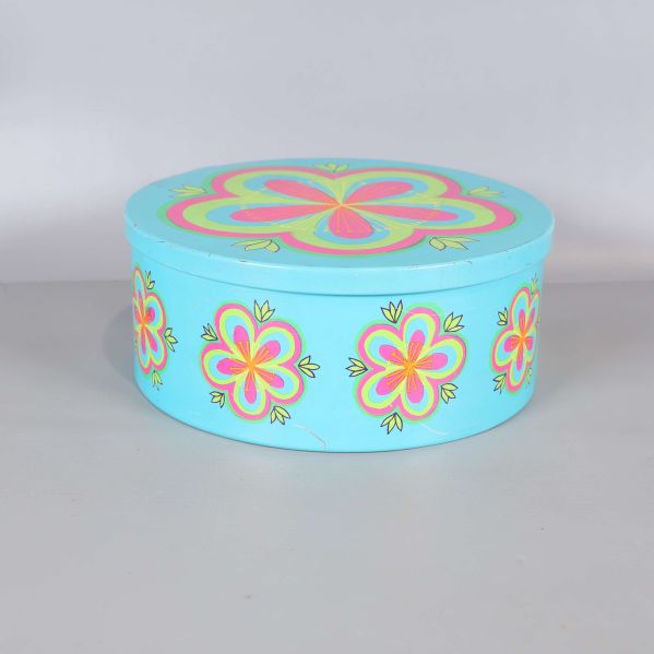 Rund turkos burk med färgglada blommor och lock