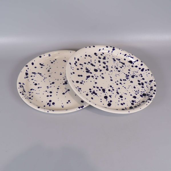 Två tallrikar med blått stänkmönster liggande