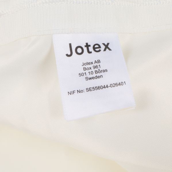 Etikett från Jotex med företagsinformation