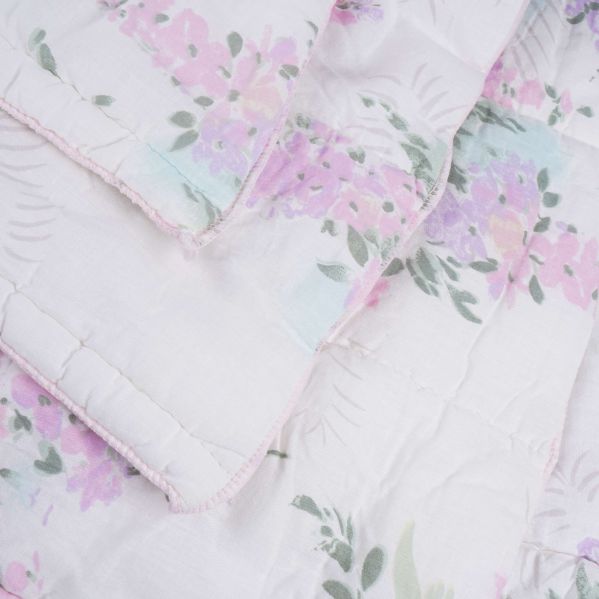 Täcke med invikta hörn och synliga sömmar