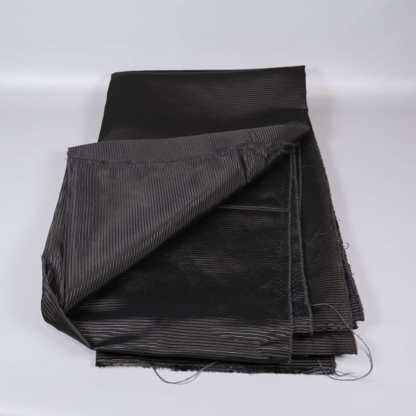 Uppvikta svart tygstycken med ribbad yta synlig