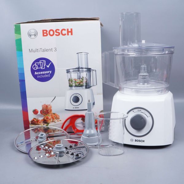 Matberedare med tillbehör framför originalförpackning från Bosch