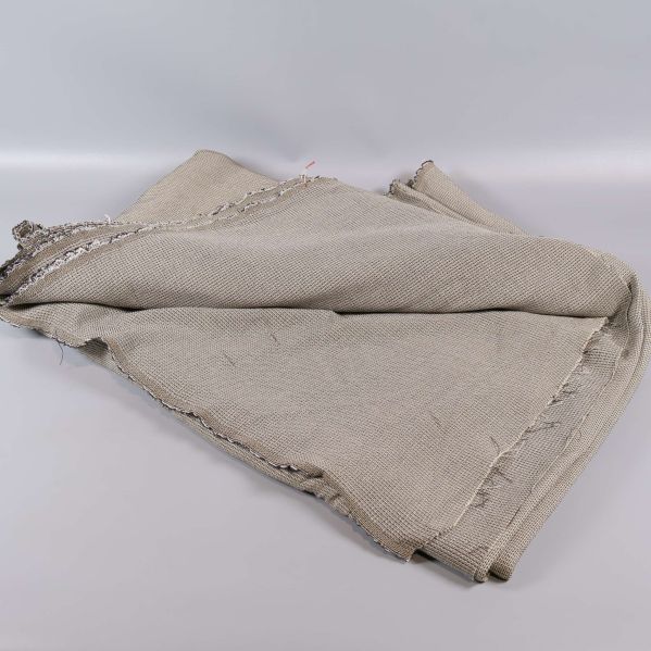 Utbredd beige textil med våfflad yta