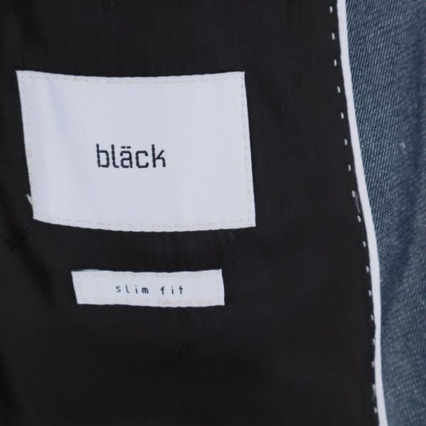 Bläcks label på insidan av kavajen