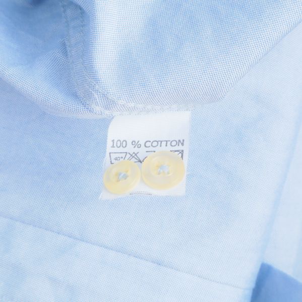 Materialetikett som visar: 100% bomull