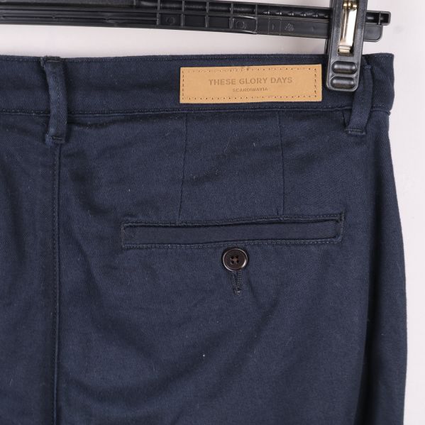 Närbild på bakficka och logotyp på byxor