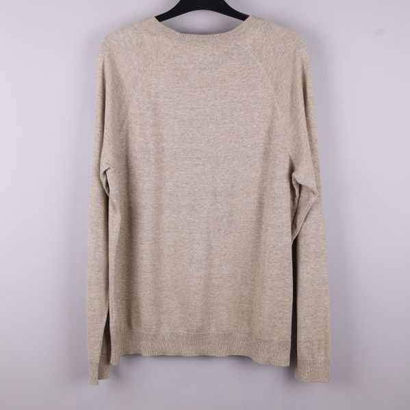 Baksidan av beige stickad tröja