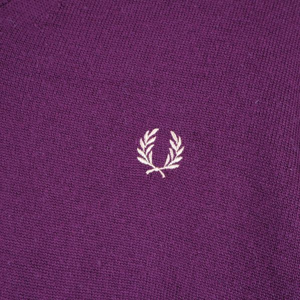 Broderat emblem på lila tröja