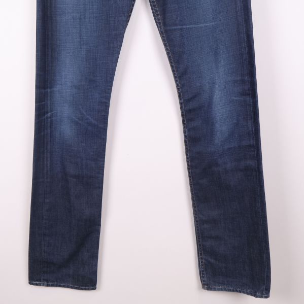 Benens nedre del med rakt avslut på blå jeans