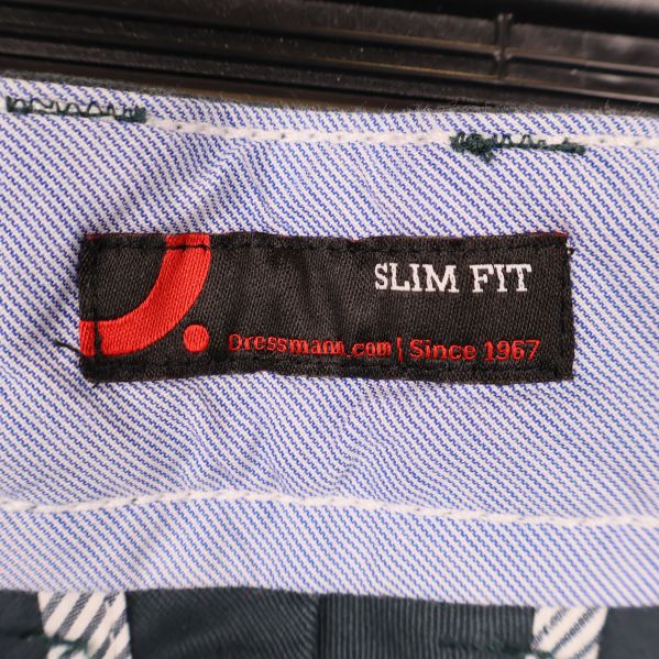 Närbild av Dressmann-slim fit-etikett och randigt innerfoder