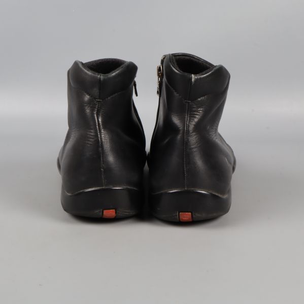 Svarta boots i skinn fotograferade bakifrån