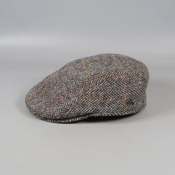 Klassisk fiskbensmönstrad tweedkeps sedd från sidan