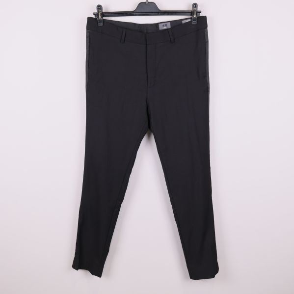 Framsida på svarta skinny fit kostymbyxor mot vit bakgrund