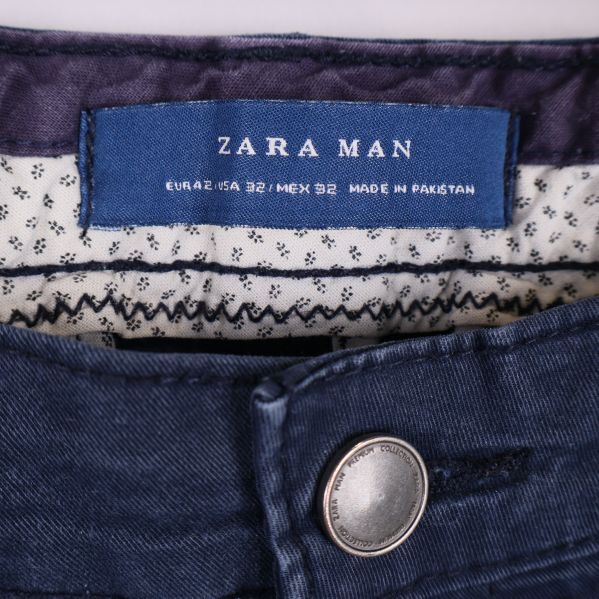 Närbild på midjepartiet och etikett med Zara Man-logga