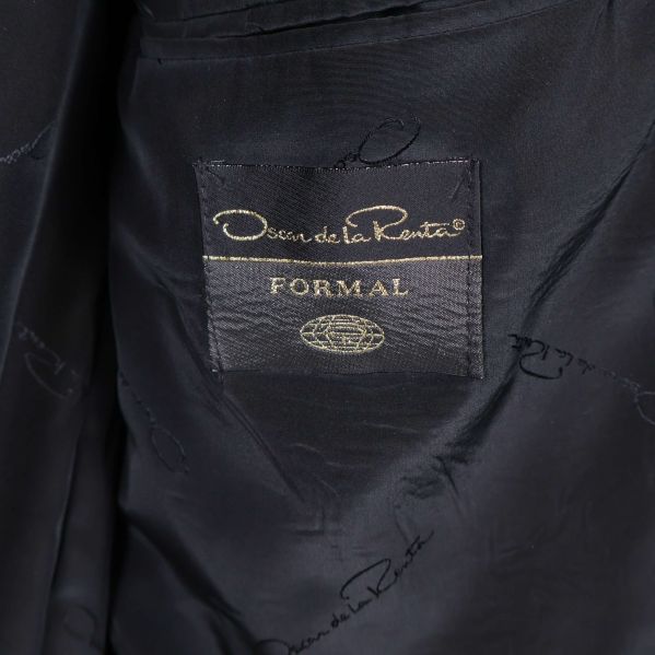 Närbild av Oscar de la Renta-logo 