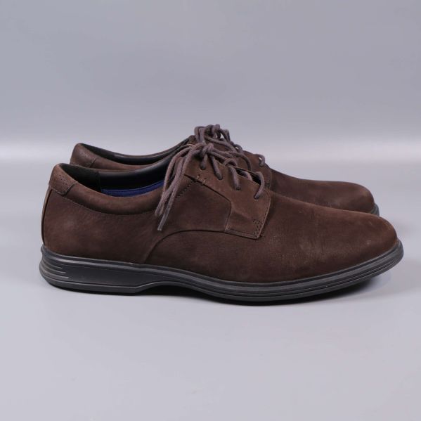 Bruna mockaskor från sidan mot grå bakgrund