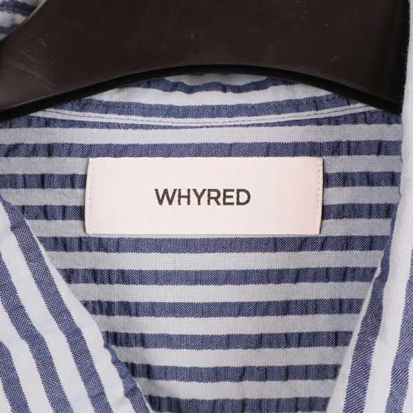 Närbild på Whyred logotyp i nacken på skjorta