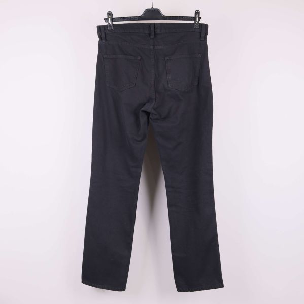 Baksida av svarta raka byxor med fickor