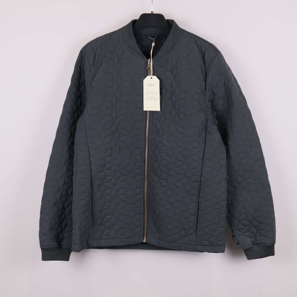 Quiltad jacka i mörk färg med blixtlås framtill