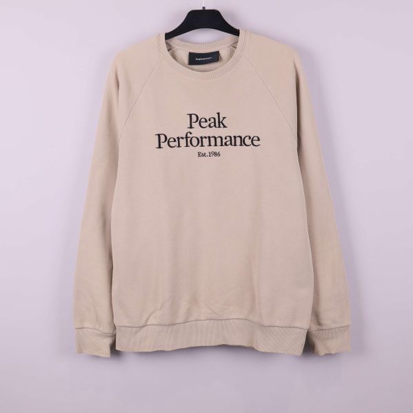 Beige Peak Performance sweatshirt framifrån på galge