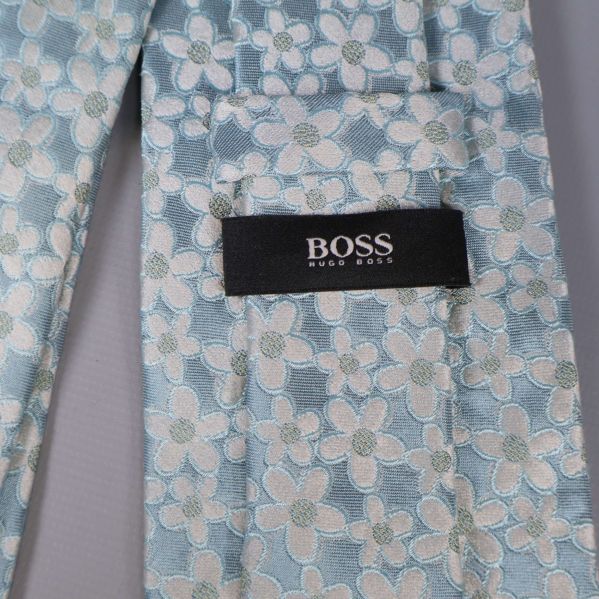 Närbild på BOSS-etikett på ljusblå slips