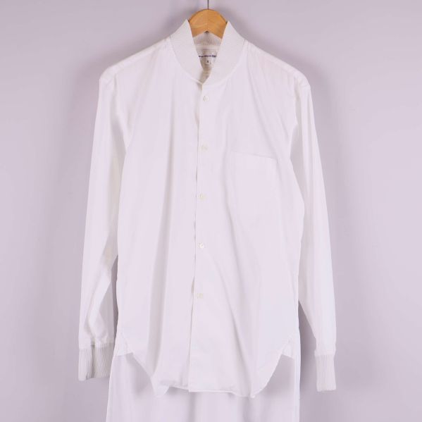 Framsida på lång vit skjorta med knäppning och bröstficka