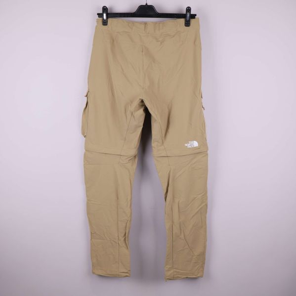 Baksida av beige friluftsbyxa med avtagbara ben