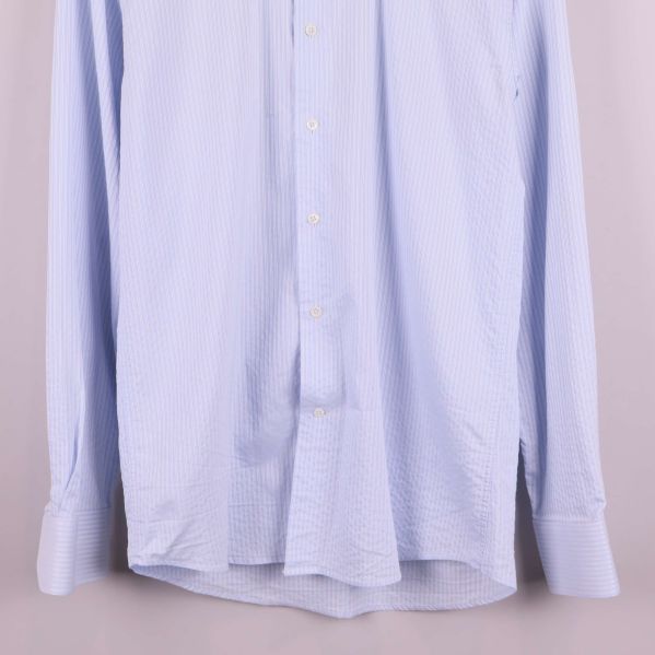 Ärmslut och nederkant på randig skjorta i ljusblått