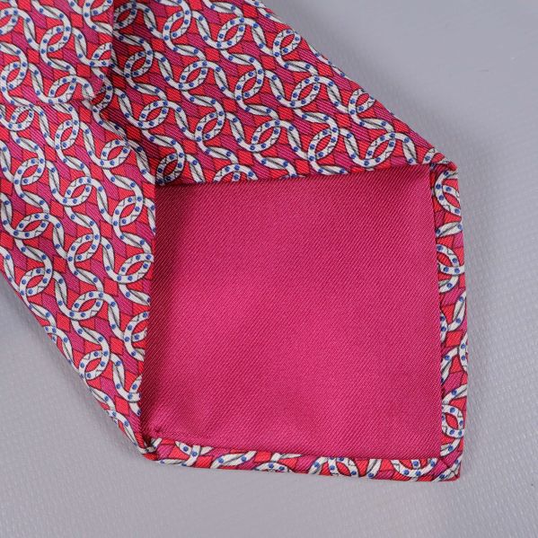 Närbild på fodrad ände i rosa tyg på Hermès slips
