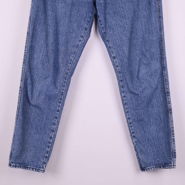 Nedre delen av raka ben på blå jeans