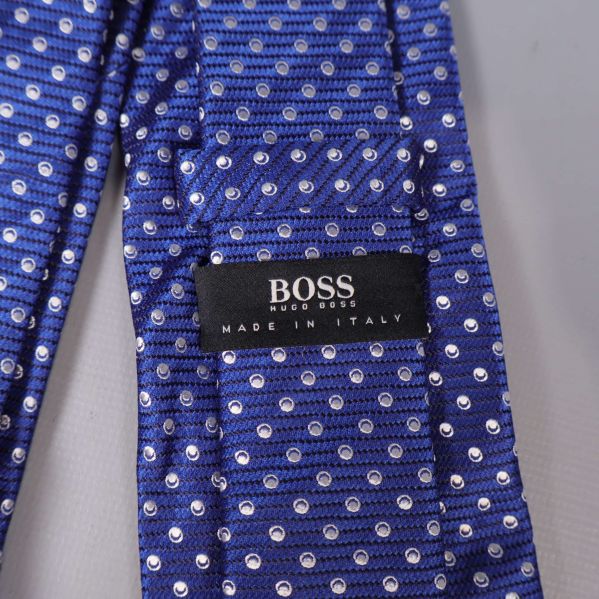 Närbild på BOSS etikett på blå slips