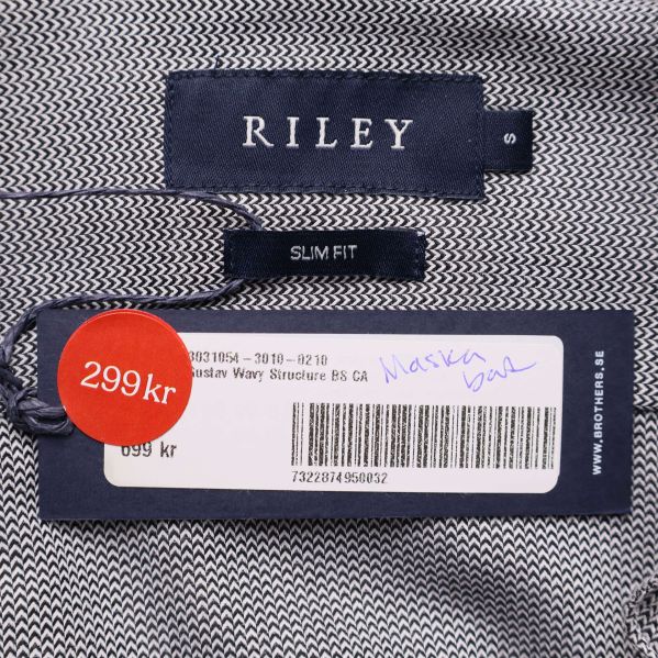 Närbild på RILEY-märke och prislapp