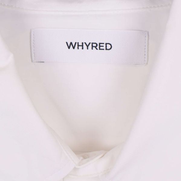Närbild på Whyred-logotyp i nacken på skjortan