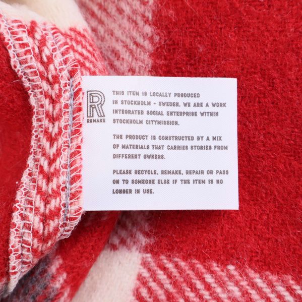 Informationsetikett om jackans ursprung och material