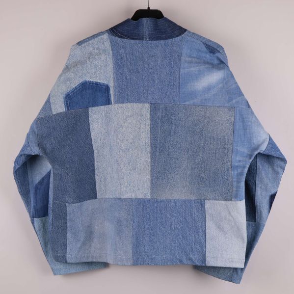 Baksidan av blå patchwork denimjacka med kontrastpaneler