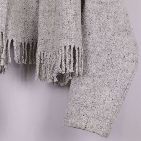 Närbild på fransar och ärmslut nedtill på jackan