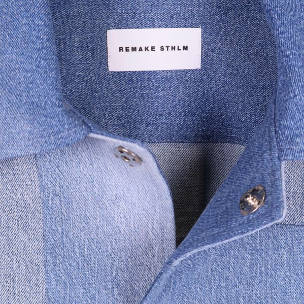 Närbild på krage och etikett Remake STHLM