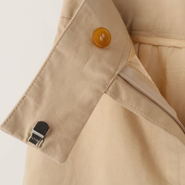 Närbild av beige kjol med knäppning